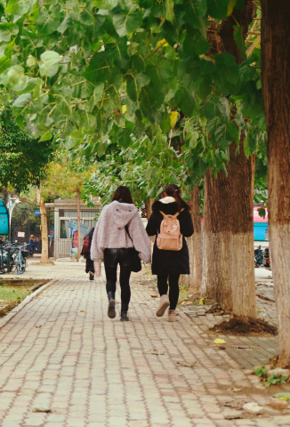 Two girls walking in school